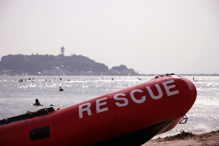 Beach with inflatable boat with “Rescue” written on the side